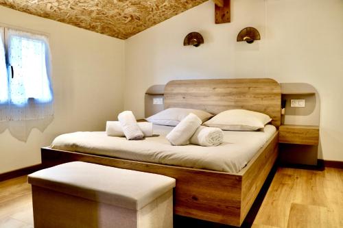 a bedroom with a large bed with white pillows at Chalet l'Escale du Cèdre in Rivières