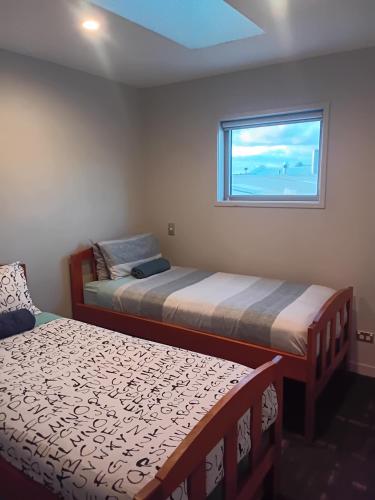 a bedroom with two beds and a window at 111 3rd Avenue Tauranga in Tauranga