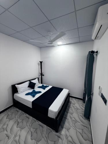 a bedroom with a bed with blue stars on it at Diving Club Beach Resort in Trincomalee