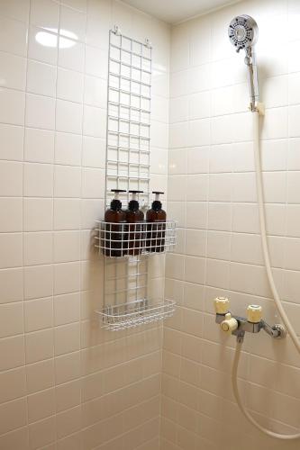 a bathroom with a shower with four bottles on a wall at パノラマスター白子-Panoramastars Shirako-星降る夜の貸切ステイ in Shirako
