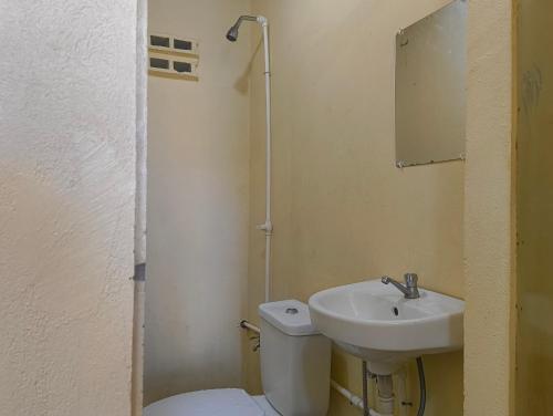 a small bathroom with a toilet and a sink at Elyu Seaside beach house in San Juan