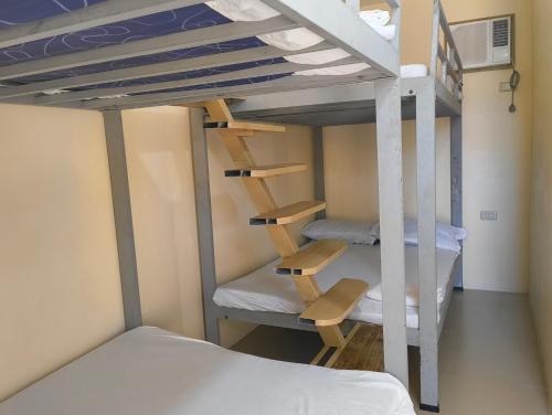 a bunk bed room with bunk beds and a bunk ladder at Elyu Seaside beach house in San Juan