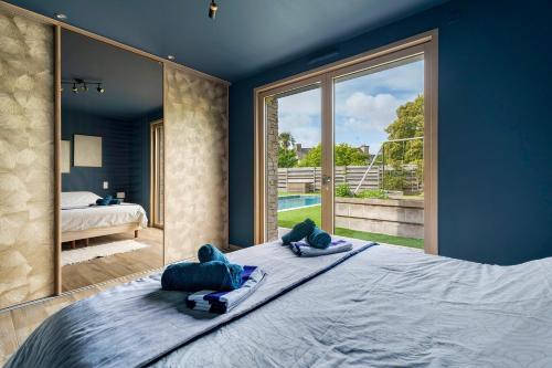 a bedroom with a large bed with two pillows on it at Breizh'ome in Saint-Cast-le-Guildo