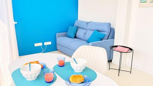 a living room with a table with food on it at Studio Ty Lys lumineux, climatisé, balcon, parking gratuit Classé 3 étoiles in Blois