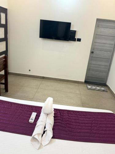 a pair of white shoes on a purple rug at Casa Branca Retreat &Hub in Varkala