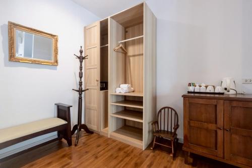 a bedroom with a bed and a cabinet and a chair at Green Gallery Beach Boutique Hotel in Hua Hin