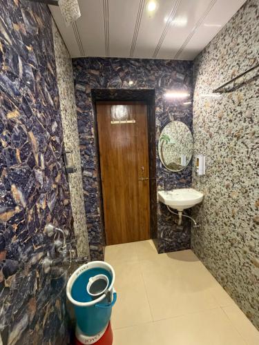 a bathroom with a sink and a toilet at New Krishna Hotel Matheran in Matheran