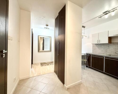 a kitchen with a door leading into a room at Central Warsaw Apartment with Pool & Sauna in Warsaw