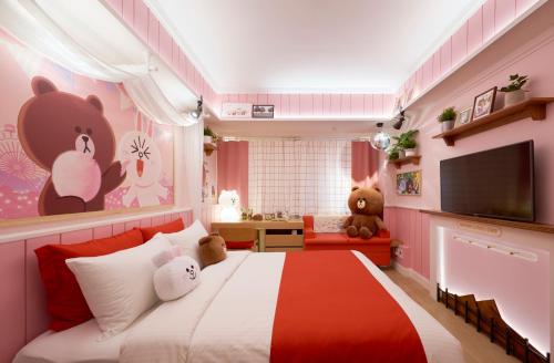 a bedroom with a large bed with teddy bears on the wall at Sotetsu Hotels The Splaisir Seoul Myeongdong in Seoul
