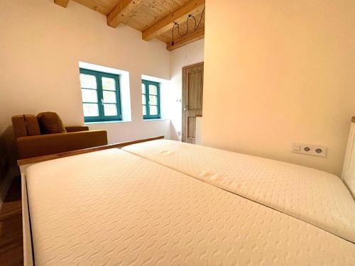 a large mattress in a room with a bed at Chalupa Renatka in Hartvíkovice