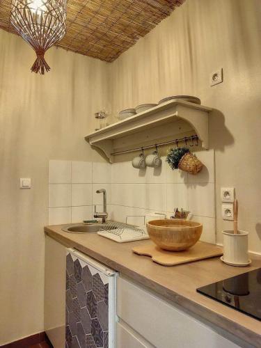 a kitchen with a sink and a bowl on a counter at Cloître in Arles