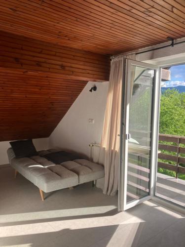a balcony with a bench and a sliding glass door at Apartments Lajk in Lesce