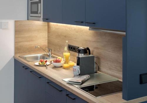 a kitchen with a sink and a counter top at Brera Serviced Apartments Singen in Singen