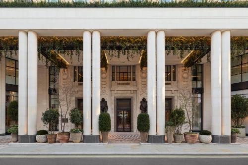 a facade of a building with columns and plants at Six Senses London in London