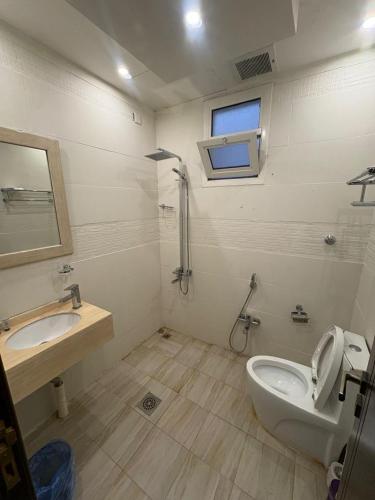 a bathroom with a toilet and a sink at ڤيا Via in Buraydah