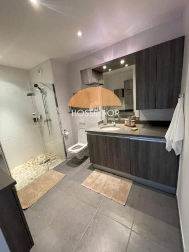 a bathroom with a shower and a sink and a toilet at Le Clos Brémontier in Soorts-Hossegor