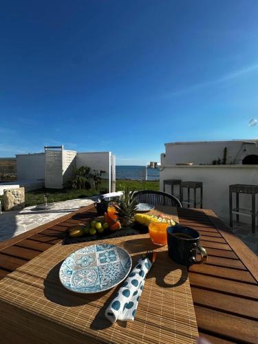 a table with a plate of food on top of a balcony at Bari Sea Paradise View in Bari