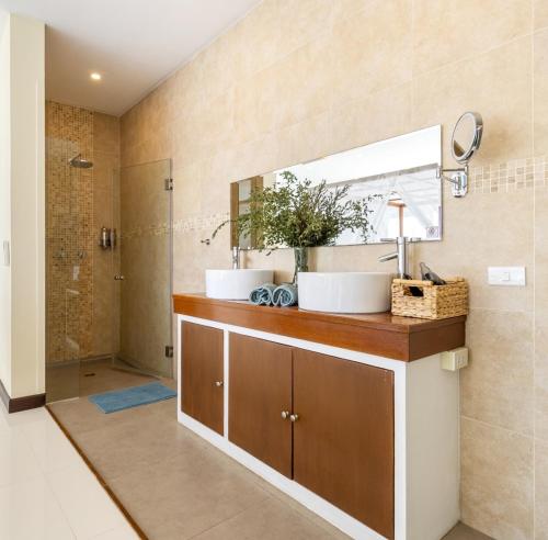 a bathroom with a sink and a mirror at Oceans Eleven Villa Samui - Oceanfront, Private Pool, Perfect for families and friends in Bangrak Beach