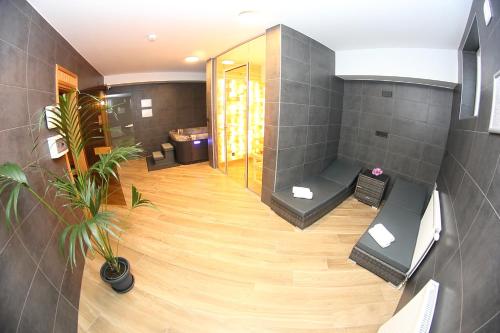 a large bathroom with a shower and a toilet at Hotel Crystal in Hajdúszoboszló