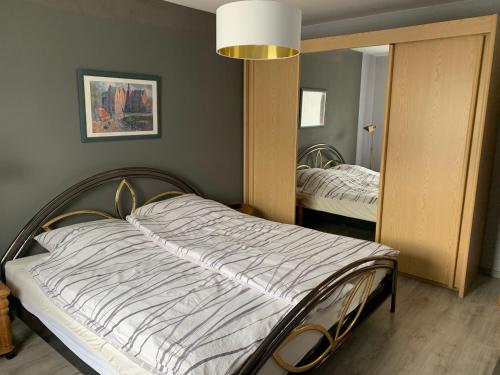 a bedroom with a bed and a large mirror at Wohnung in ruhiger Wohnlage in Bad Kreuznach