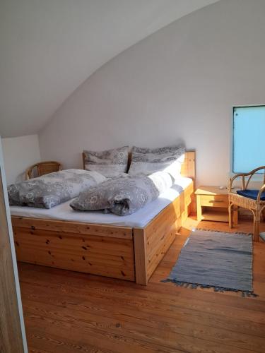 a bedroom with a large wooden bed in a room at Appartement Sonnblick in Breitenbrunn