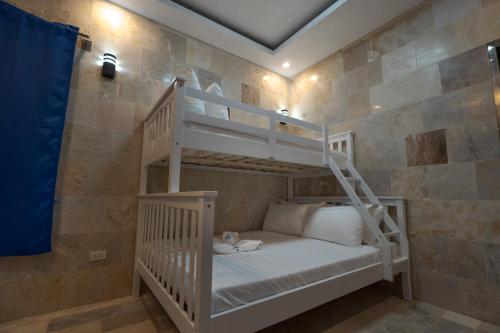 a bedroom with a bunk bed with a ladder at IT Farm Resort in Rizal