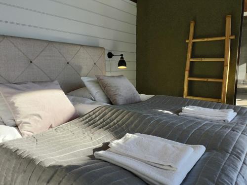 a bedroom with two beds with towels on them at Luksushuvila yksityisellä SPA-alueella ja järvinäköalalla in Ähtäri