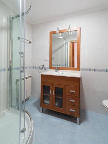 a bathroom with a sink and a mirror at El Balcon de Moaña in Moaña