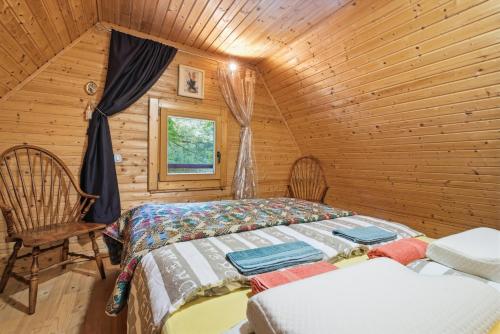a bedroom with a bed in a wooden cabin at Fairy Tale House in Trenta