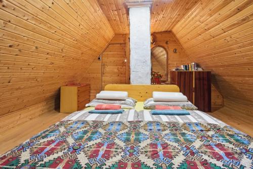 a bedroom with two beds in a wooden room at Fairy Tale House in Trenta