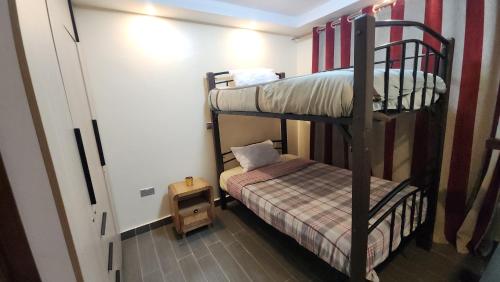a room with two bunk beds and a small bed at Blooming Sanctuary in Ruiru