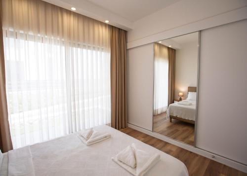 a bedroom with a large mirror and a bed at Aqualina D5-1 by HolidayKeys in Kyrenia