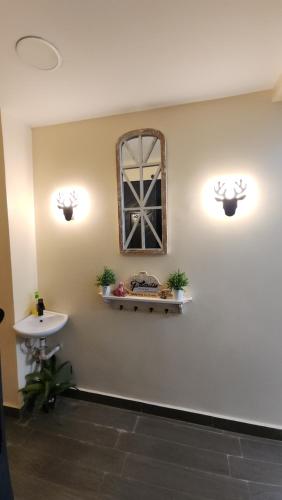 a bathroom with a sink and a mirror on the wall at Blooming Sanctuary in Ruiru
