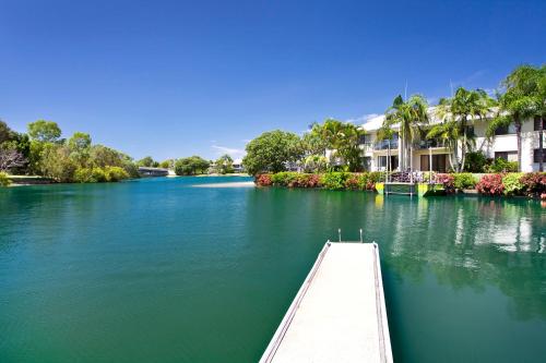 a view of a river with a pier and houses at Culgoa Point Beach Resort in Noosa Heads