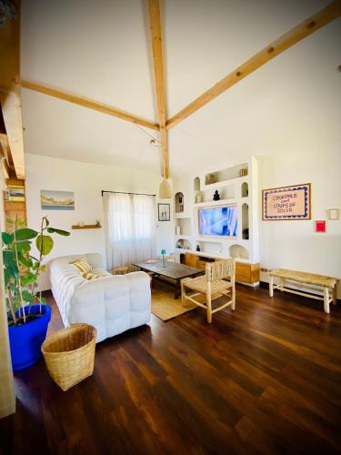a living room with a white couch and a table at Villa between forest and ocean in Labenne