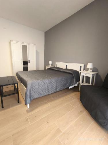 a bedroom with a bed and a table and two chairs at dante 55 in Agrigento