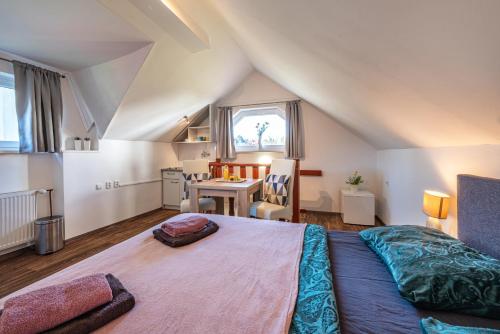a bedroom with a large bed in a attic at Pension Elbrs in Mariánské Lázně