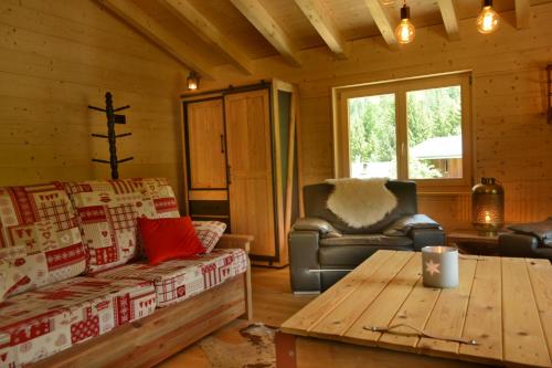 a living room with a couch and a table at Chalet Rustifol in Orsières