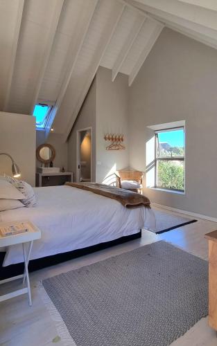 a bedroom with a large bed and a large window at St Francis Cottage close to beach in St Francis Bay
