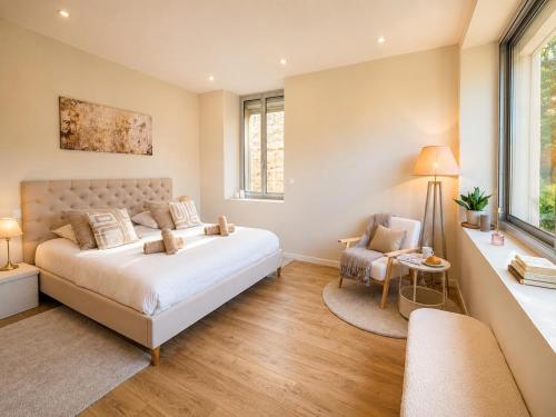a bedroom with a large bed and a window at Villa Prestige - Maison d Hôtes avec Piscine, Billard et Parking Privé - Centre 5 min - Proche A7-A9 in Orange
