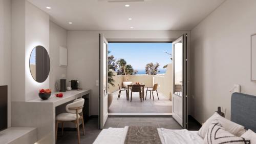a kitchen and dining room with a view of a table at Terracotta Sunset Suites in Oia