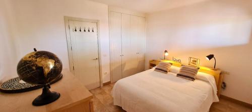 a bedroom with a bed and a globe on a desk at Jardín del Teide in Puerto de la Cruz
