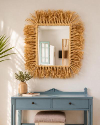 a blue dressing table with a mirror on a wall at Kurmulis Studios in Stalos