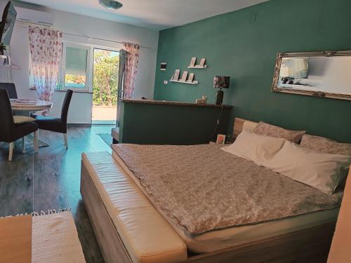 a bedroom with a large bed and a table at Apartment Laura in Senj