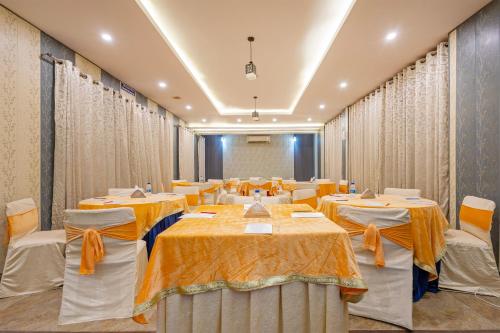 a conference room with tables and chairs and curtains at Treebo Ivy Castle in Gurgaon