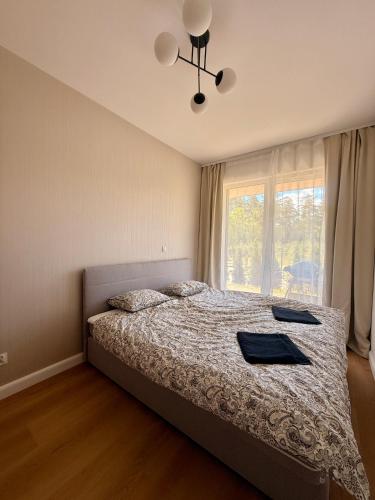 a bedroom with a bed and a window at Marina Augustów - BRYZA in Augustów