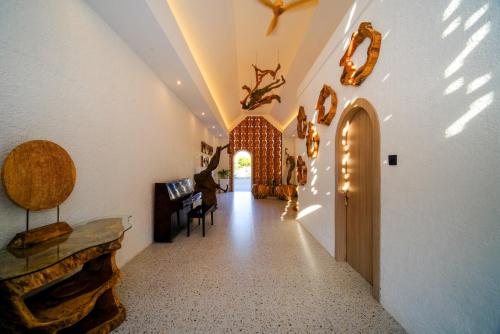 a hallway of a home with a door and a table at Serenity Garden Villas by Danka Hospitality in Hang Nadim International Airport