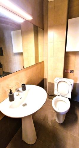 a bathroom with a white sink and a toilet at Villa Galani Afitos in Afitos