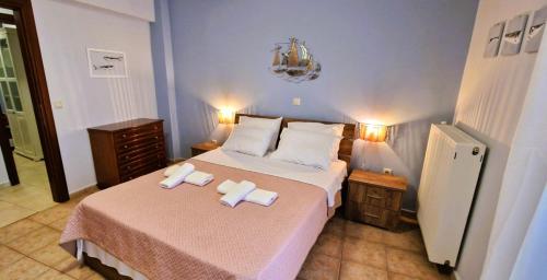a bedroom with two beds with towels on them at Villa Galani Afitos in Afitos