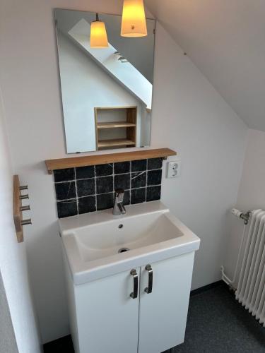 a bathroom with a white sink and a mirror at Fantastic accommodation in central Kalmar in Kalmar